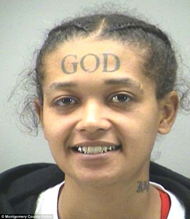 A woman with a GOD tattoo on her forehead has been arrested