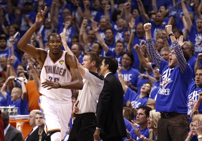 Oklahoma City Thunder's Kevin Durant (L) celebrates a three point basket against the Miami Heat during the fourth quarter in Game 1 of the NBA basketball finals in Oklahoma City, Oklahoma, June 12, 2012.